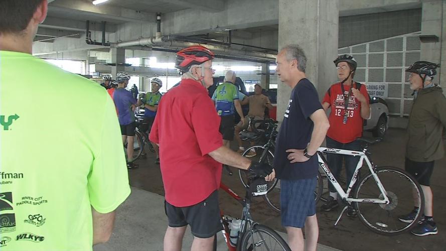 Louisville Mayor Greg Fischer talks to a cyclist at the Ali Memorial Bike Ride