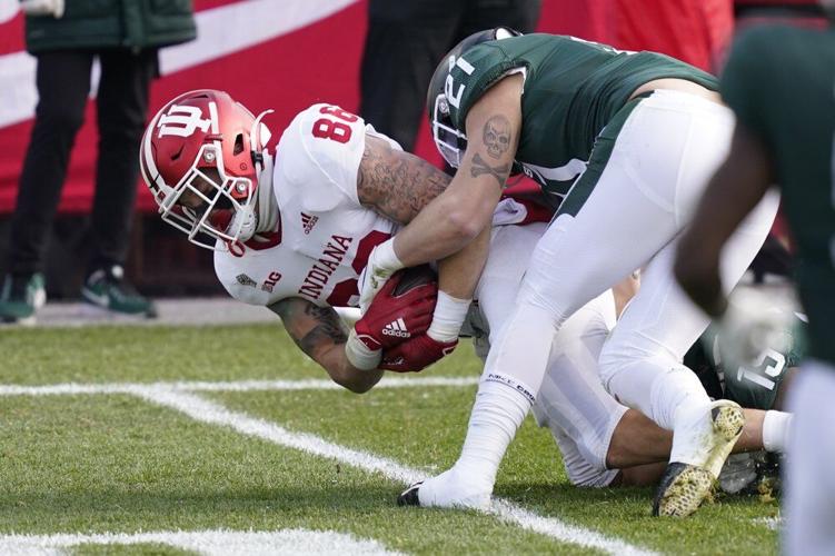 Indiana tight end Peyton Hendershot (86) is tackled by Michigan State linebacker Chase Kline