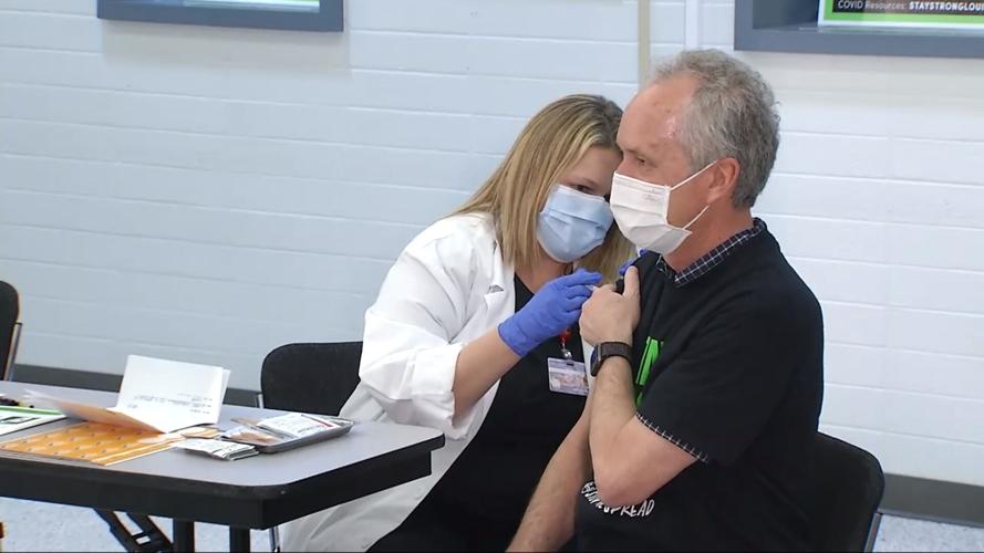 Louisville Mayor Greg Fischer receives a dose of Moderna's COVID-19 vaccine