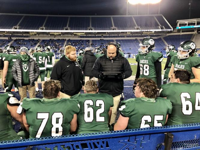 Trinity football players and coaches gather on the sidelines of Kroger Field during 6A title game vs. Male (12-19-20)