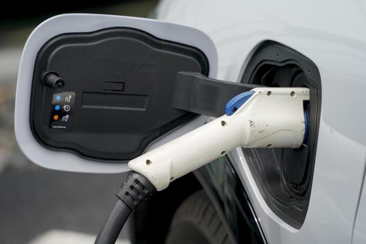 Electric vehicle charges at Ford dealership
