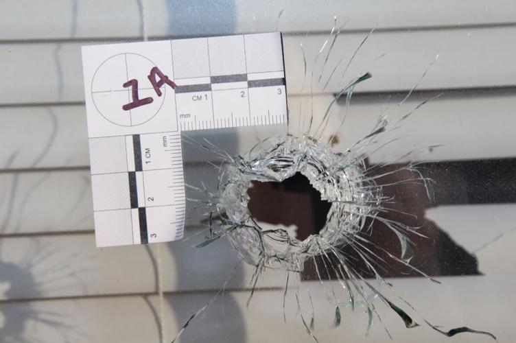 A bullet hole in a window to Breonna Taylor's apartment
