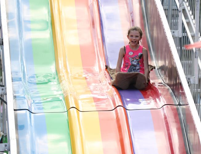 Girl goes down slide at the fair