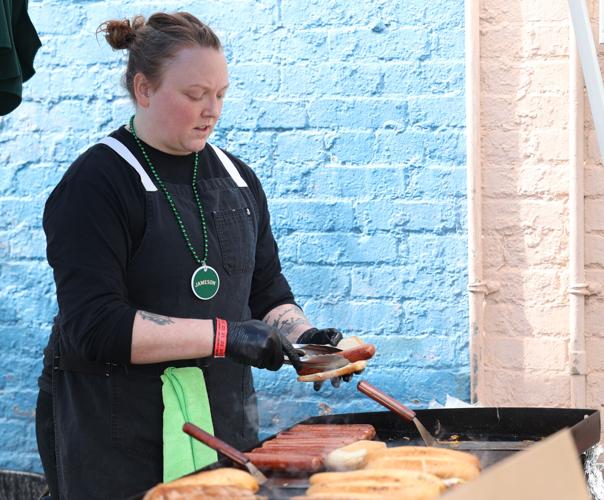 Woman prepares hot dog at parade