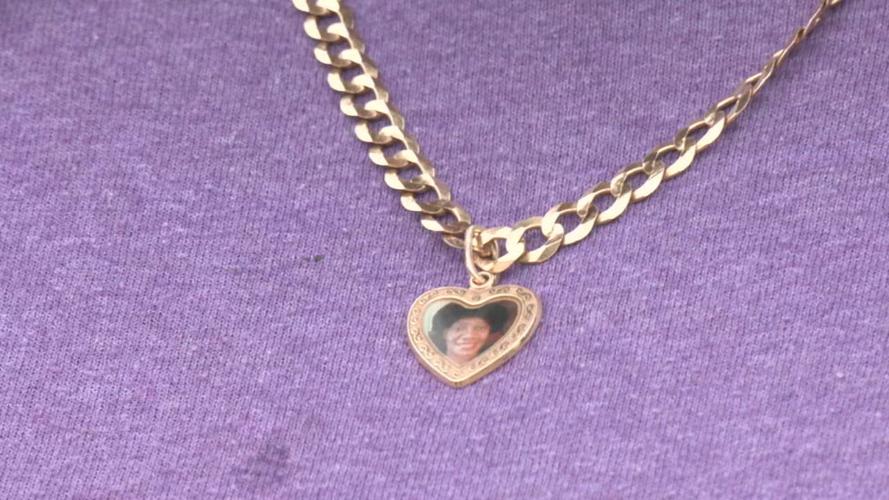 Sharbai White wears a necklace with her mother, Mae White's picture.