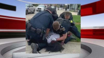 Louisville Metro Police officers arresting Denorver Garrett at Jefferson Square Park