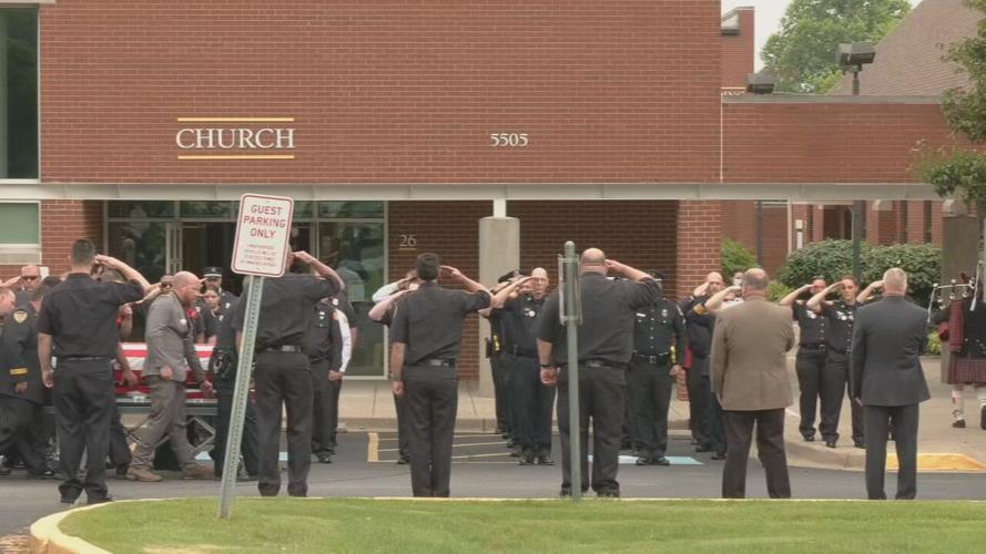 Firefighters salute at Kyle Adams funeral