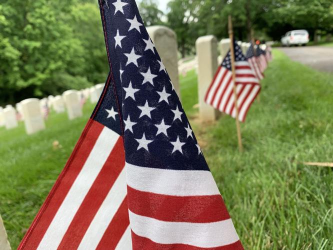 Flags placed on the graves of veterans at Cave Hill Cemetery on Friday, May 27, 2022