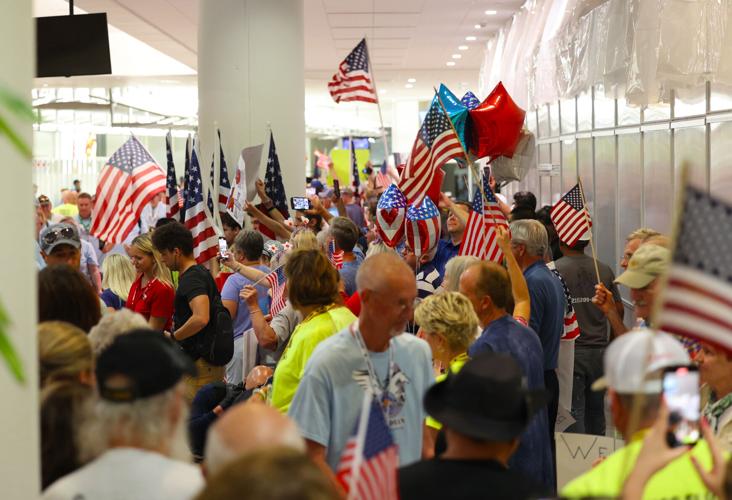 American flags wave as veterans pass by.JPG