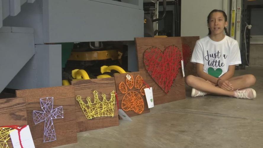 Megan Chelliah poses with string art creations