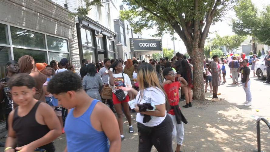 Crowds outside the Oneness Boutique on Bardstown Road to get free shoes and backpacks