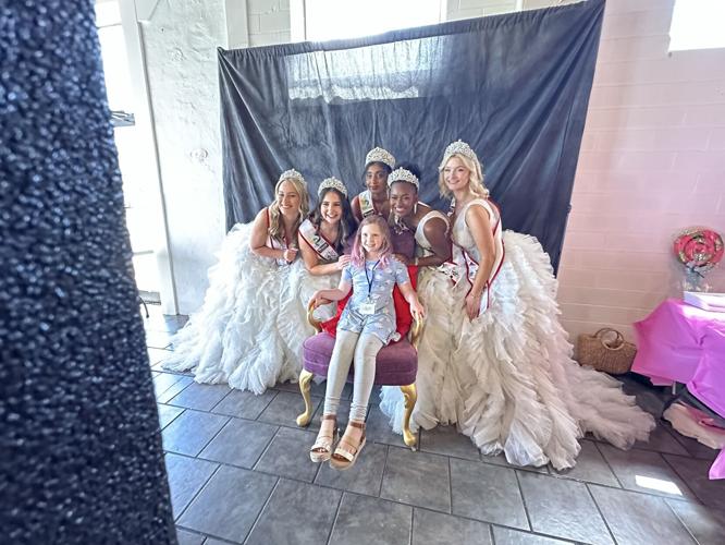 Royal Court takes photo with child.jpg