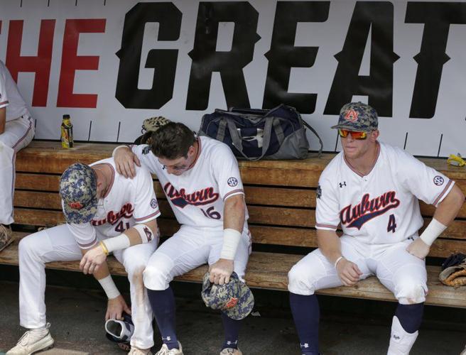 Auburn's Steven Williams (41), Kason Howell (16) and Rankin Woley (4) sit in the dugout