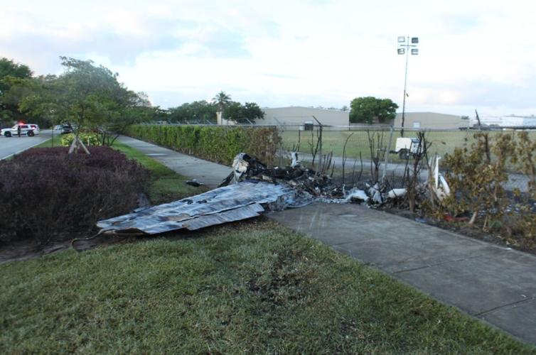 The wreckage of the small plane after it crashed into Bishops car and ultimately impacted a perimeter fence of the airport.jpg
