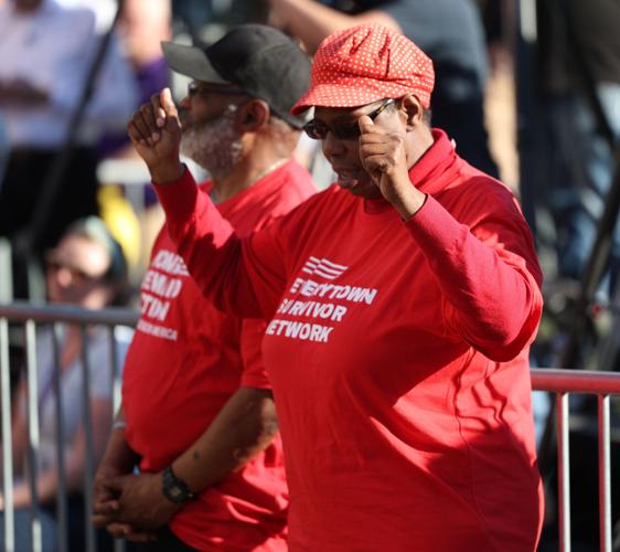 Woman raises arms at vigil.JPG