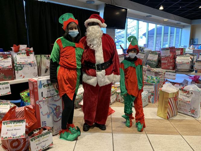 Santa and elves with presents for St. Stephen Church's Guardian Angels Initiative