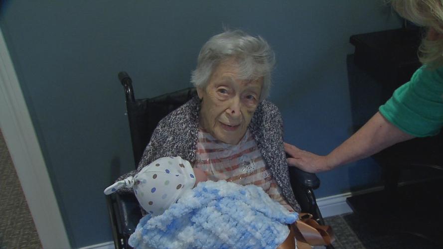 Senior with baby doll brought by Pearl's Memory Babies