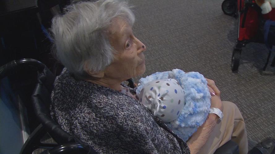 Senior with baby doll brought by Pearl's Memory Babies