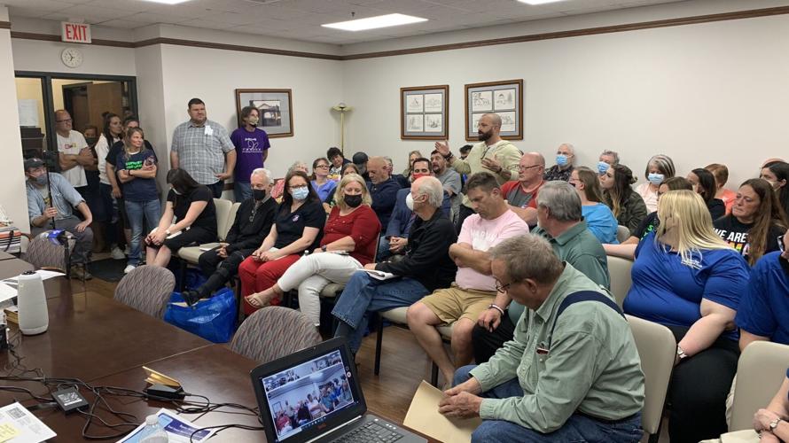 A man speaks up during a meeting of Scott County, Ind., commissioners