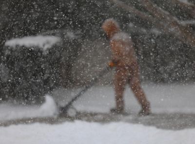 Man shovels snow in snow - Jan. 5, 2025.JPG