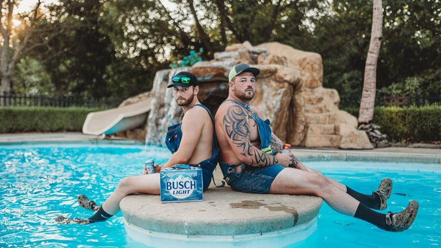 Skyler Ipock and Aaron Brothers sit at the pool