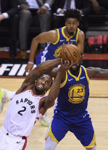 Kawhi Leonard battles for the ball