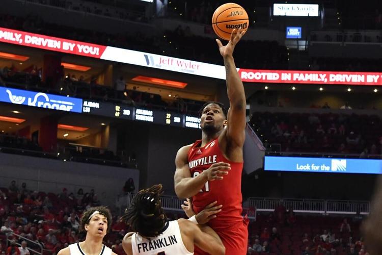 Louisville forward Sydney Curry shoots over Virginia guard Armaan Franklin.jpeg