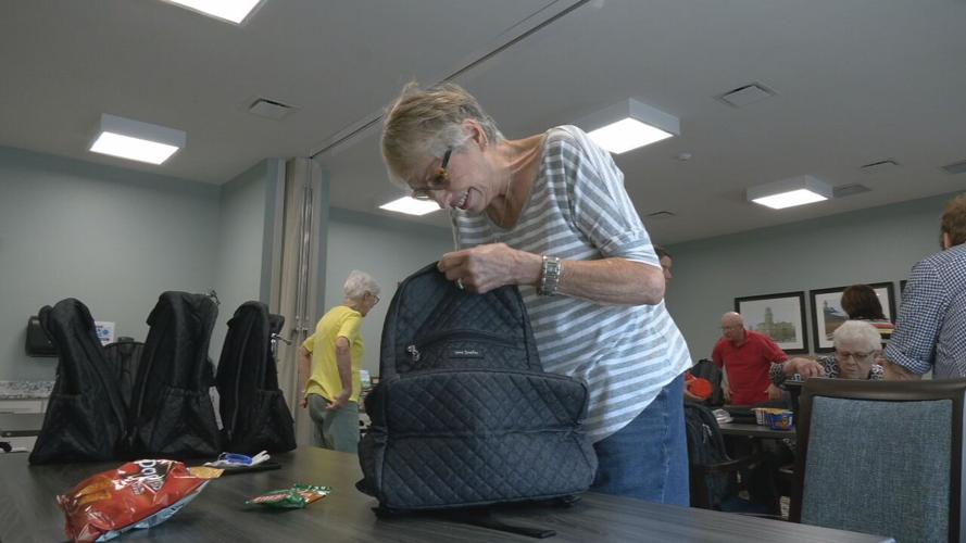 SENIORS STUFFING BACKPACKS FOR KIDS.jpeg