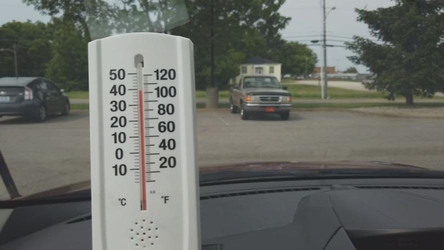 Thermometer on car dashboard