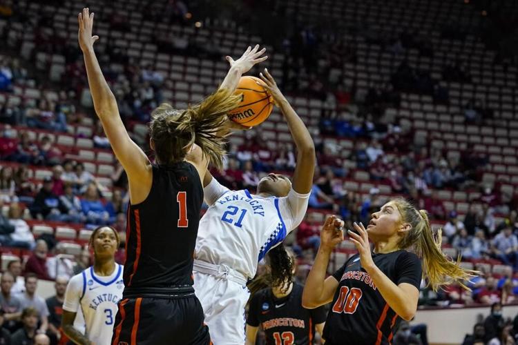 Kentucky forward Nyah Leveretter shot is blocked as she shoots between Princeton guards.jpeg