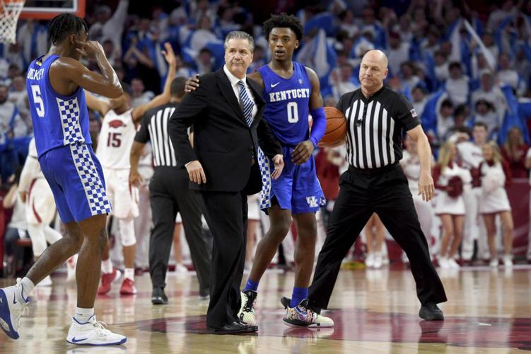 Kentucky players Ashton Hagans (0) and Immanuel Quickley (5) walk with head coach John Calipari