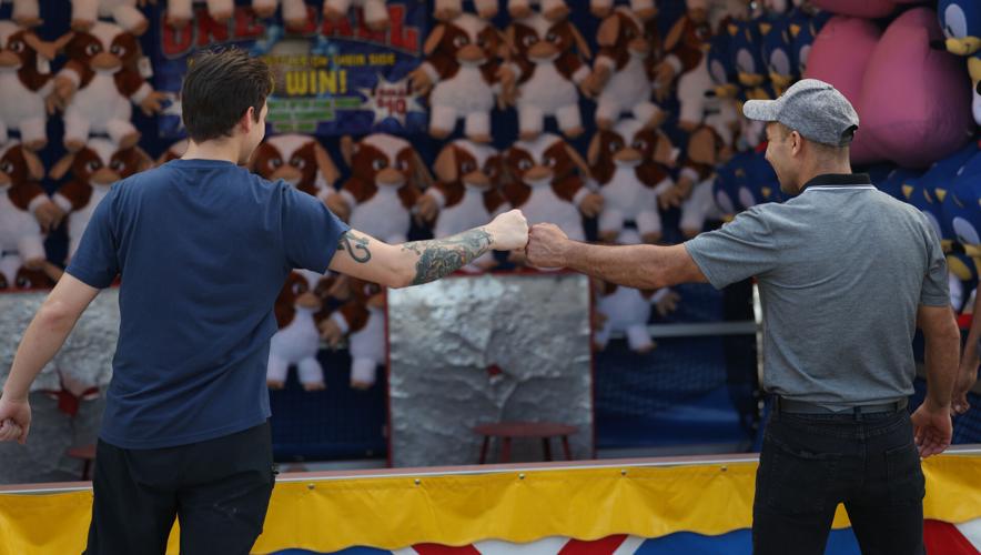 Two men fist bump at state fair