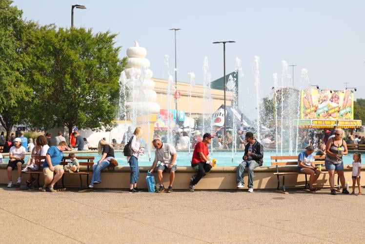 People sit by water fountain at state fair.JPG
