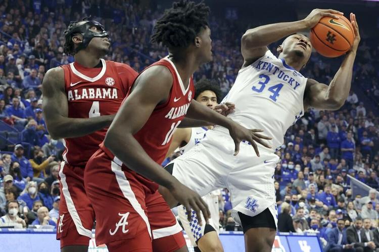 Kentucky's Oscar Tshiebwe pulls down a rebound near Alabama's Juwan Gary and Jahvon Quinerly.jpeg