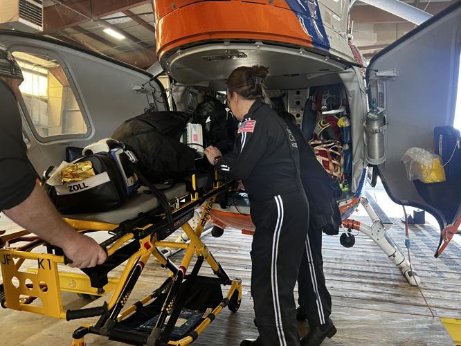 Equipment is loaded into the back of the Norton Children's 'Just for Kids' helicopter
