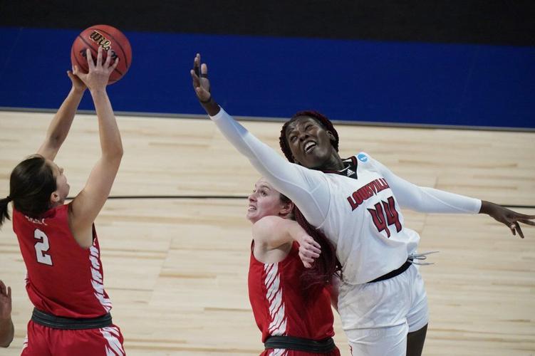 Marist guard Allie Best (2) grabs a rebound out to the reach of Louisville forward Olivia Cochran