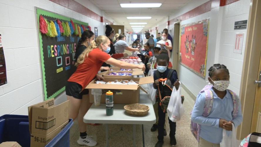 Blessings in a Backpack volunteers hand out much-needed food to students at Engelhard Elementary School