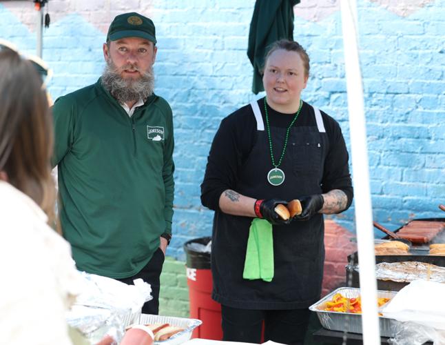 Vendors talk to people at parade