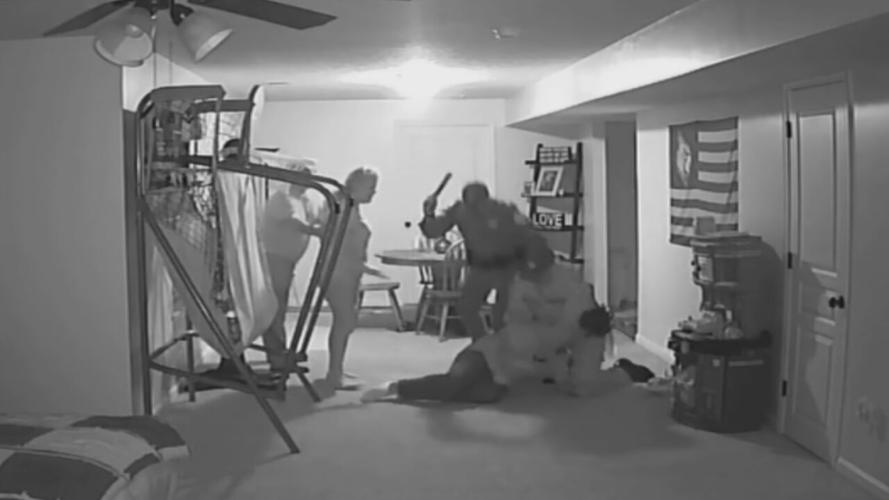 KSP Trooper Thomas Czartorski raises flashlight above prone suspect