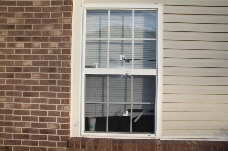 Bullet holes in a window of Breonna Taylor's apartment