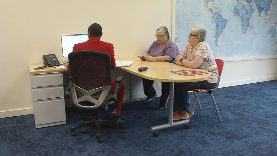 Cecilia Christensen and Jennifer Cecil talk with Linda Caso, a travel agent in Louisville