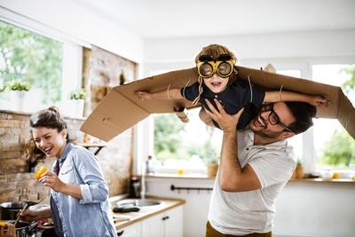 FILE - CHILD AND PARENTS PLAYING