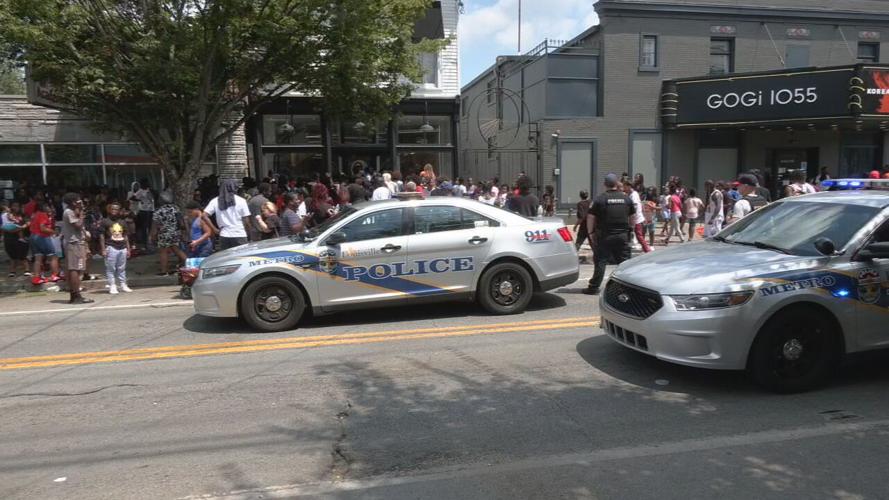 Crowds outside the Oneness Boutique on Bardstown Road to get free shoes and backpacks