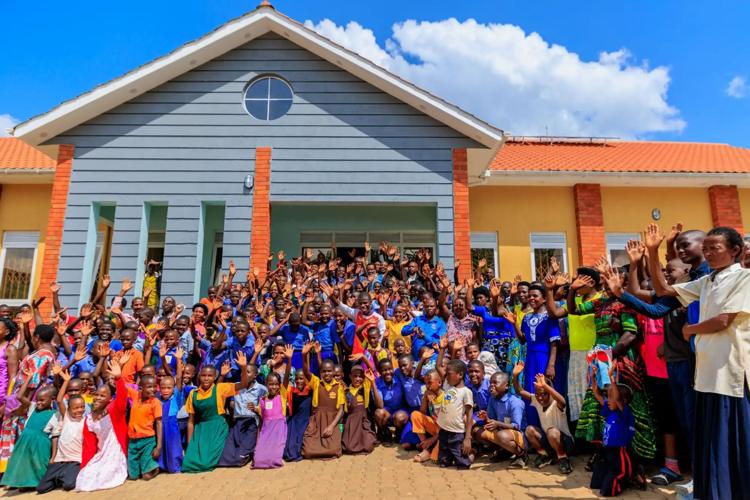 Students wave at Bwoga library.jpg