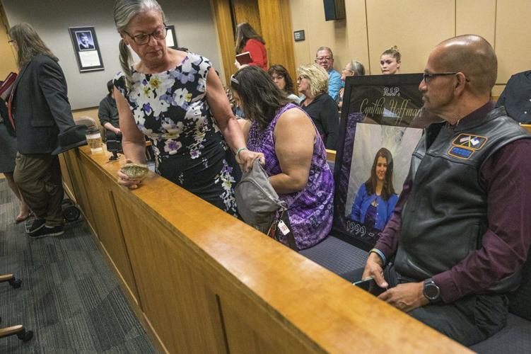 Timothy Hoffman sits next to a picture of his daughter Cynthia Hoffman