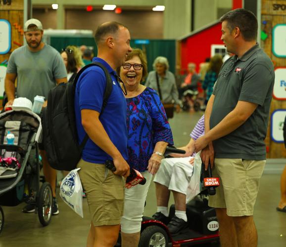 Dalton Godbey and Chris Sutter talk to a woman at fair.JPG