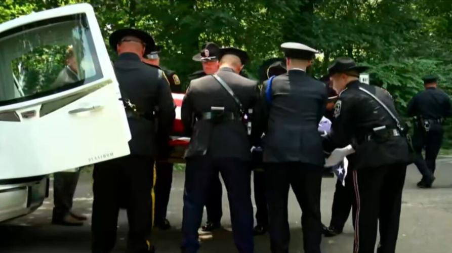 Pallbearers with Brandon Shirley's casket at Cave Hill