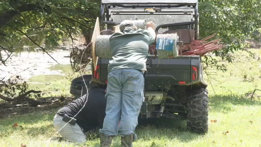Gary Imel cleans up after flooding in Manville, Indiana