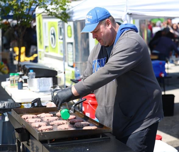 Man grills hamburgers at Bock fest.JPG