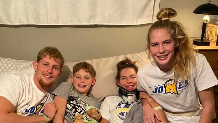 Hunter, Creek, Amy and Ava Jones smile for picture back in their KS home